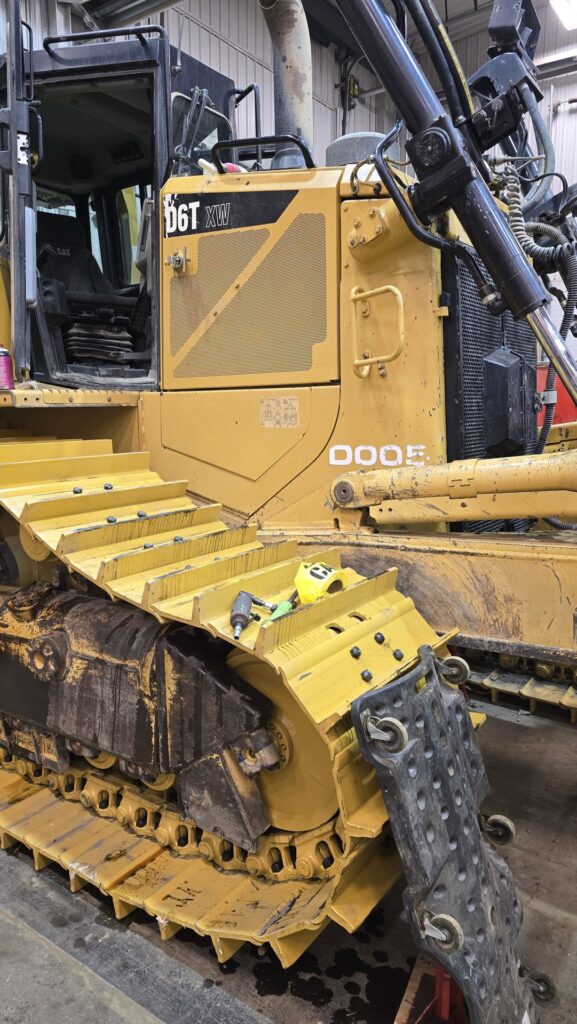 Heavy equipment welding repair on a crawler dozer