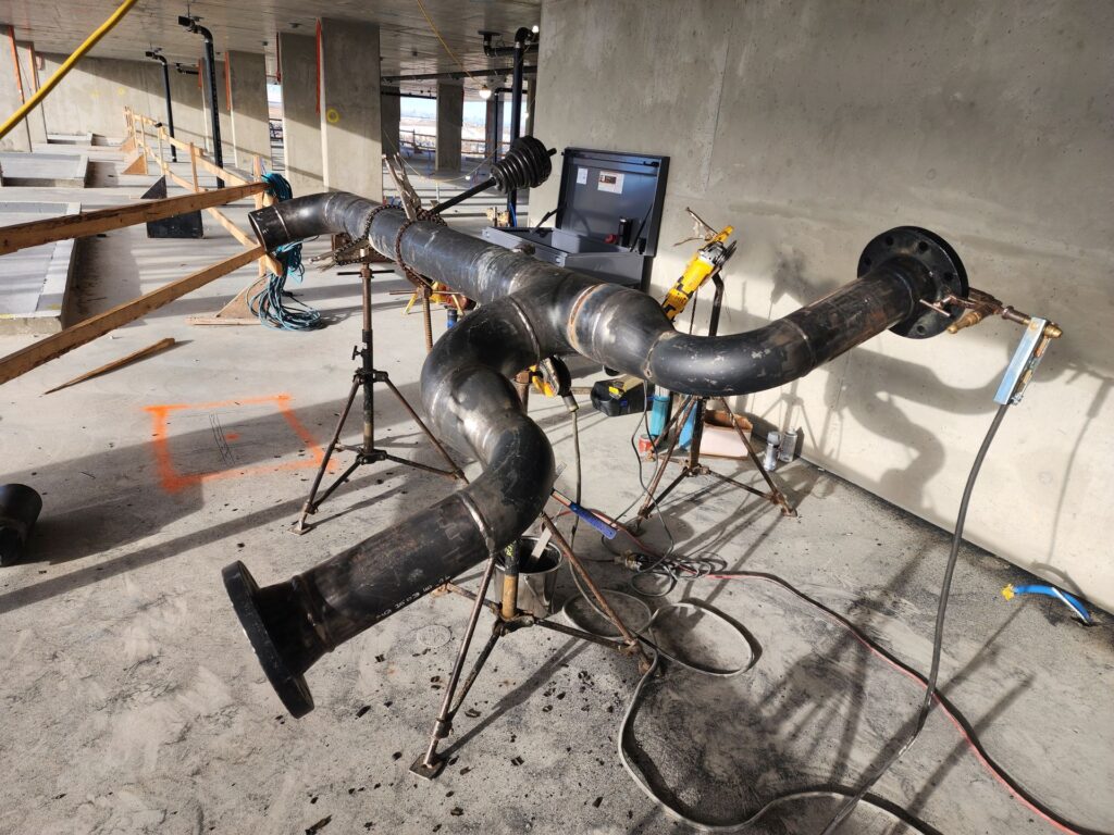 Fabricated pipe header spool with welded outlets