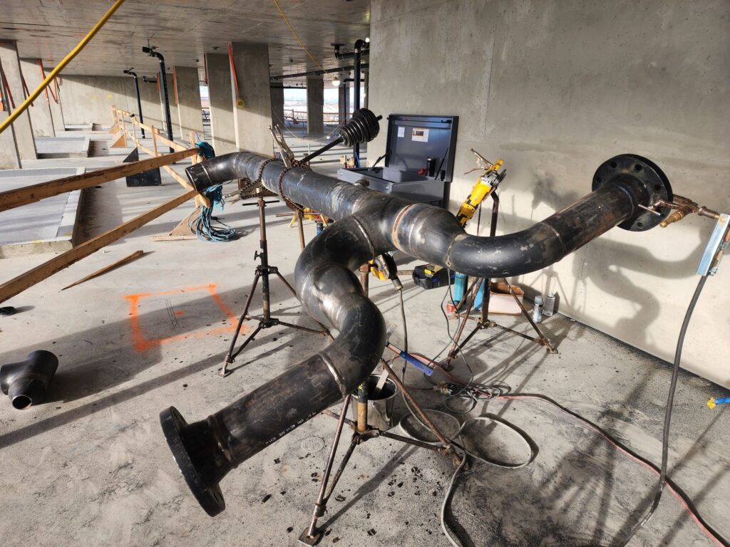 Custom welded pipe header on fabrication stands