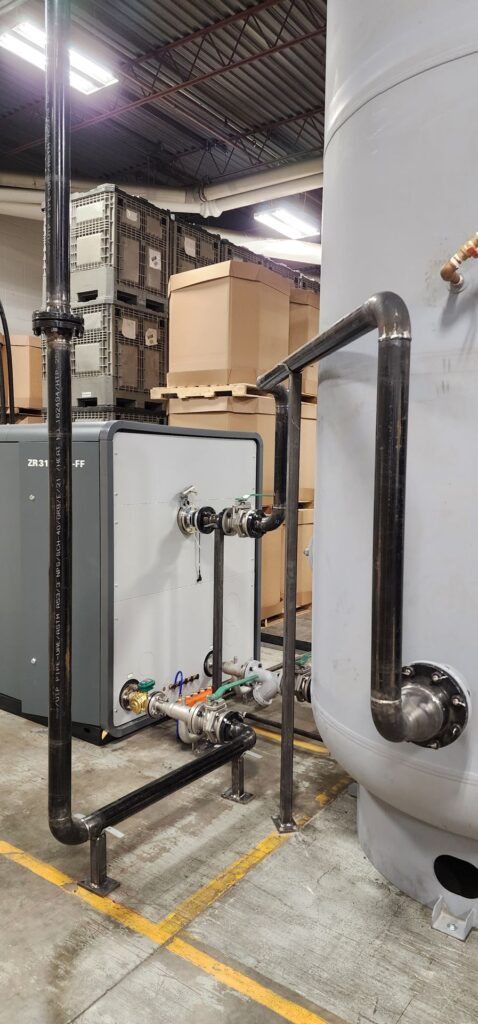 Welded black iron piping on a mechanical room tank installation