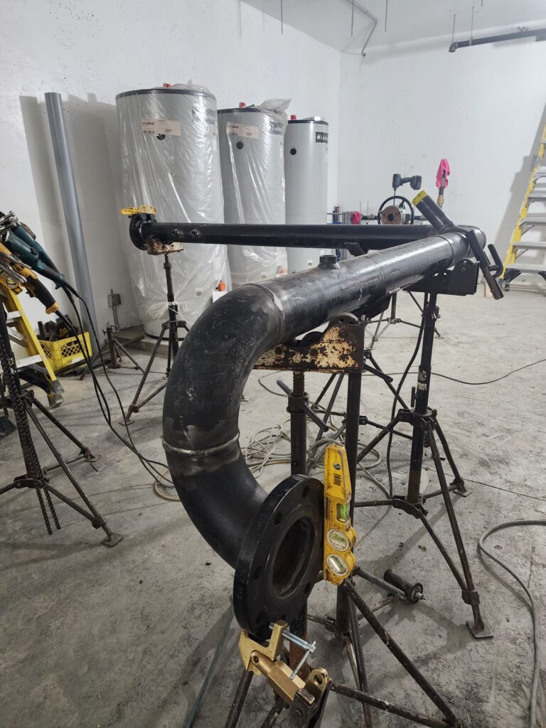 Large black iron pipe spool for a mechanical room