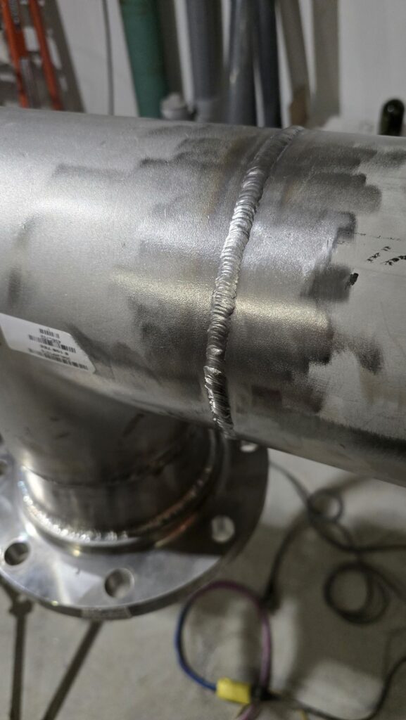 TIG welds on a stainless steel pipe assembly