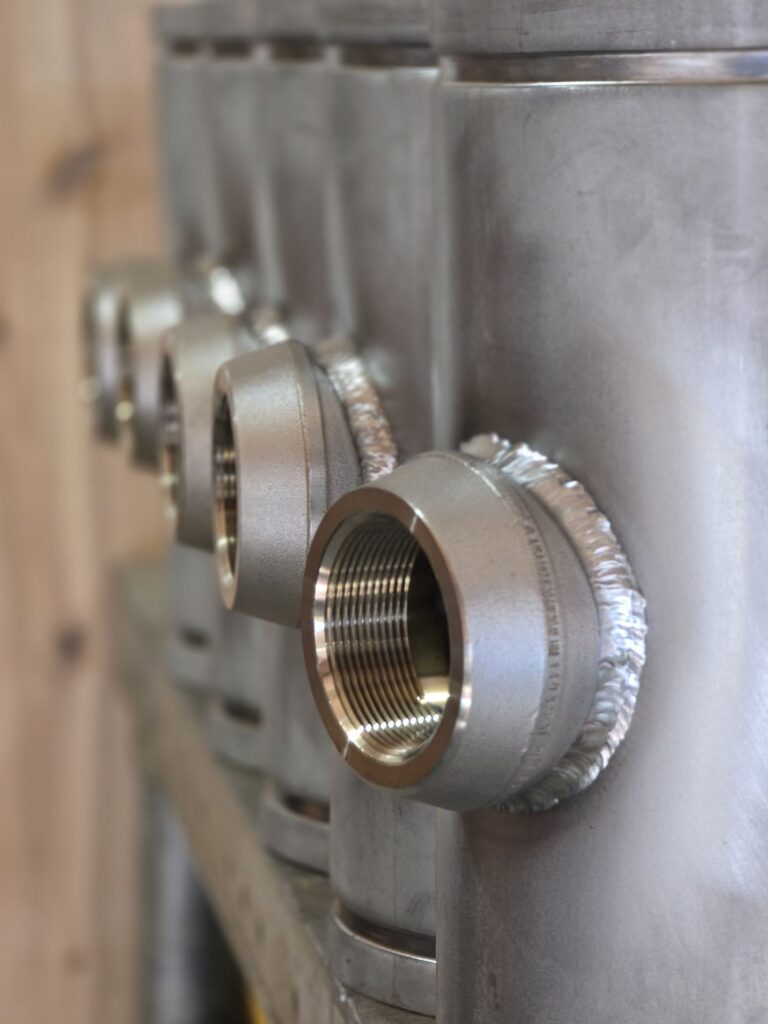 TIG welded couplings on a stainless steel manifold