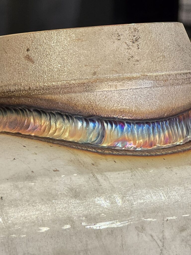 Close-up of a TIG weld cap on stainless steel pipe